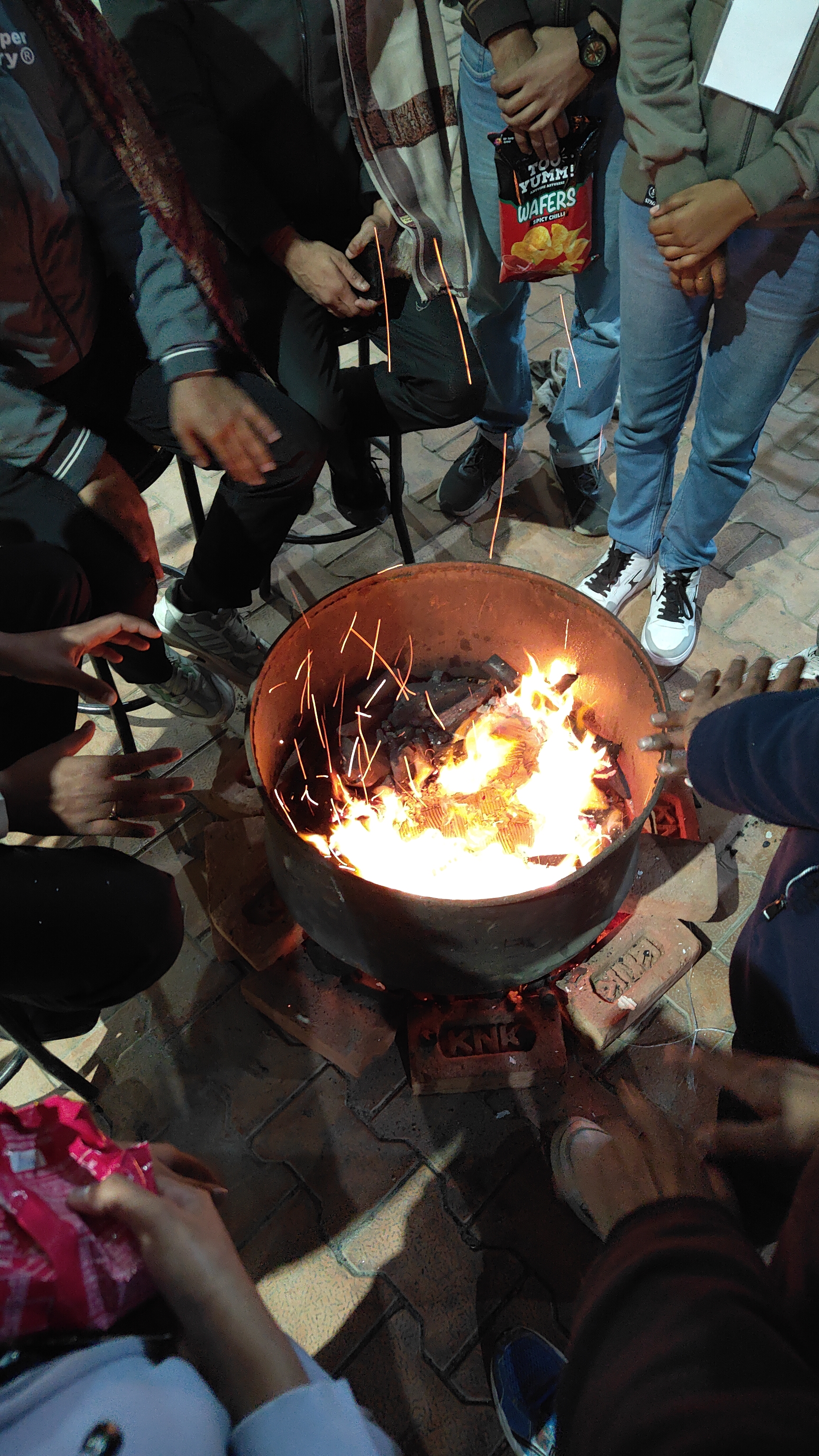 Team warming hands at bonfire during cold nights at Smart India Hackathon 2024
